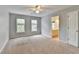 Neutral bedroom featuring a ceiling fan, carpet, and natural light from the windows at 10460 Cranchester Way, Alpharetta, GA 30022