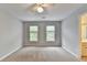 Neutral bedroom with a ceiling fan and view of the outdoor scenery at 10460 Cranchester Way, Alpharetta, GA 30022