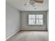 This is a cozy bedroom featuring neutral carpet and a bright window for natural light at 10460 Cranchester Way, Alpharetta, GA 30022