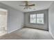 Bedroom featuring neutral paint, carpet flooring, and a large window with natural light at 10460 Cranchester Way, Alpharetta, GA 30022
