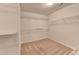 Walk-in closet featuring carpeted flooring and wire shelving at 10460 Cranchester Way, Alpharetta, GA 30022