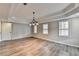 Bright dining room with hardwood floors, modern lighting, and plentiful windows at 10460 Cranchester Way, Alpharetta, GA 30022