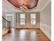 Dining room features hardwood floors, crown molding, and two windows for natural light at 10460 Cranchester Way, Alpharetta, GA 30022