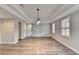 Bright dining room features hardwood floors, elegant lighting, and three windows at 10460 Cranchester Way, Alpharetta, GA 30022