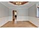 Dining room featuring hardwood floors, traditional trim, and access to the kitchen at 10460 Cranchester Way, Alpharetta, GA 30022