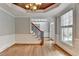 Dining room showcases hardwood floors, trim detail, a staircase and view of the front entry at 10460 Cranchester Way, Alpharetta, GA 30022