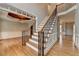 Spacious foyer with hardwood floors, staircase with iron spindles, and elegant trim detailing, showcasing the home's craftsmanship at 10460 Cranchester Way, Alpharetta, GA 30022