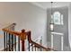 Elevated view of the front door and a stylish pendant light from the staircase at 10460 Cranchester Way, Alpharetta, GA 30022