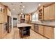 Well-appointed kitchen featuring stainless steel appliances, center island and custom cabinets at 10460 Cranchester Way, Alpharetta, GA 30022