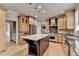 Spacious kitchen featuring a center island with a granite countertop, custom cabinets and stainless appliances at 10460 Cranchester Way, Alpharetta, GA 30022
