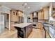 Spacious kitchen featuring granite island, stainless steel appliances, and wood floors at 10460 Cranchester Way, Alpharetta, GA 30022