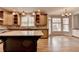 Open kitchen featuring a large island, modern appliances, and ample natural light at 10460 Cranchester Way, Alpharetta, GA 30022