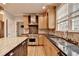 Bright kitchen featuring wood cabinets, granite counters, stainless steel appliances, and large island at 10460 Cranchester Way, Alpharetta, GA 30022