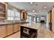 Kitchen featuring granite counters, wood cabinets, island, and hardwood floors at 10460 Cranchester Way, Alpharetta, GA 30022