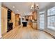 Spacious kitchen with wood cabinets, granite countertops, stainless appliances, and a black island at 10460 Cranchester Way, Alpharetta, GA 30022