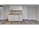 A kitchenette includes white cabinetry, a built-in microwave, and an under-counter refrigerator at 10460 Cranchester Way, Alpharetta, GA 30022