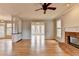Large living room featuring a brick fireplace and an adjacent sunroom with many windows at 10460 Cranchester Way, Alpharetta, GA 30022
