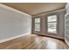Empty living room featuring hardwood floors, crown molding and a neutral color scheme, ready for personalization at 10460 Cranchester Way, Alpharetta, GA 30022