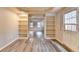This cozy living room features sleek gray flooring and built-in shelving at 10460 Cranchester Way, Alpharetta, GA 30022