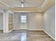 This bright living room features sleek gray flooring and built-in shelving at 10460 Cranchester Way, Alpharetta, GA 30022