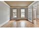 Empty living room featuring hardwood floors, crown molding and a neutral color scheme, ready for personalization at 10460 Cranchester Way, Alpharetta, GA 30022