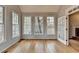 Bright living room featuring hardwood floors, neutral paint, and three large windows at 10460 Cranchester Way, Alpharetta, GA 30022