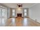 Bright living room with a brick fireplace and large windows providing lots of natural light at 10460 Cranchester Way, Alpharetta, GA 30022