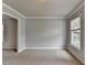 Living room featuring plush carpeting and a large window providing lots of natural light at 10460 Cranchester Way, Alpharetta, GA 30022