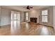 Bright living room with a brick fireplace and large windows providing lots of natural light at 10460 Cranchester Way, Alpharetta, GA 30022