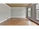 Empty living room featuring hardwood floors, crown molding and a neutral color scheme, ready for personalization at 10460 Cranchester Way, Alpharetta, GA 30022