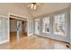 Open concept living room with hardwood floors, vaulted ceiling, and lots of natural light at 10460 Cranchester Way, Alpharetta, GA 30022