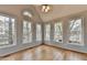 Charming sunroom with numerous windows providing picturesque views of the surrounding trees at 10460 Cranchester Way, Alpharetta, GA 30022