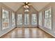Bright sunroom with vaulted ceilings and multiple windows offering serene views of the outdoors at 10460 Cranchester Way, Alpharetta, GA 30022