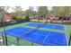Aerial view of well-maintained tennis courts in a serene community setting at 10460 Cranchester Way, Alpharetta, GA 30022