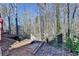 A backyard with trees and leaves on the ground, featuring an open area at 1924 Wilkenson Xing, Marietta, GA 30066