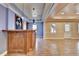 Wet bar with wooden cabinets, pendant lights, and access to other areas of the basement at 1924 Wilkenson Xing, Marietta, GA 30066
