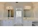 Bright bathroom featuring a double vanity, mirrors and access to the bedroom and other bathroom features at 1924 Wilkenson Xing, Marietta, GA 30066