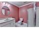Bathroom with a single sink vanity, shower and frosted shower door plus a round mirror at 1924 Wilkenson Xing, Marietta, GA 30066