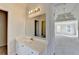 Bright bathroom featuring a vanity and a mirror with access to the bedroom and another bathroom space at 1924 Wilkenson Xing, Marietta, GA 30066