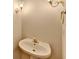 Cozy half bathroom with a pedestal sink and decorative lighting at 1924 Wilkenson Xing, Marietta, GA 30066