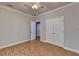 Bedroom with light-colored walls, wood floors, closet and a view into a blue painted room at 1924 Wilkenson Xing, Marietta, GA 30066