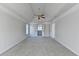 Spacious bedroom featuring neutral walls, carpeting, and a fan with an open closet at 1924 Wilkenson Xing, Marietta, GA 30066