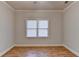 Bedroom with light-colored walls, wood floors and a window to let in lots of light at 1924 Wilkenson Xing, Marietta, GA 30066