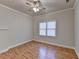 Bedroom with light-colored walls, wood floors and a window to let in lots of light at 1924 Wilkenson Xing, Marietta, GA 30066