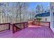 Exterior deck with red-painted wooden surface and railing, providing outdoor space and wooded view at 1924 Wilkenson Xing, Marietta, GA 30066