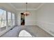 Open dining area features a decorative chandelier, chair rail, and large windows at 1924 Wilkenson Xing, Marietta, GA 30066