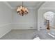 Bright dining area featuring elegant chandelier, chair rail, and staircase at 1924 Wilkenson Xing, Marietta, GA 30066