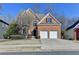 Charming two-story brick home with a well-manicured lawn, two-car garage, and a welcoming front entrance at 1924 Wilkenson Xing, Marietta, GA 30066