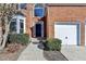 Front door of brick home with landscaped bushes lining the walkway at 1924 Wilkenson Xing, Marietta, GA 30066