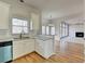 Kitchen features stainless appliances, white cabinets, and a view to the living room at 1924 Wilkenson Xing, Marietta, GA 30066